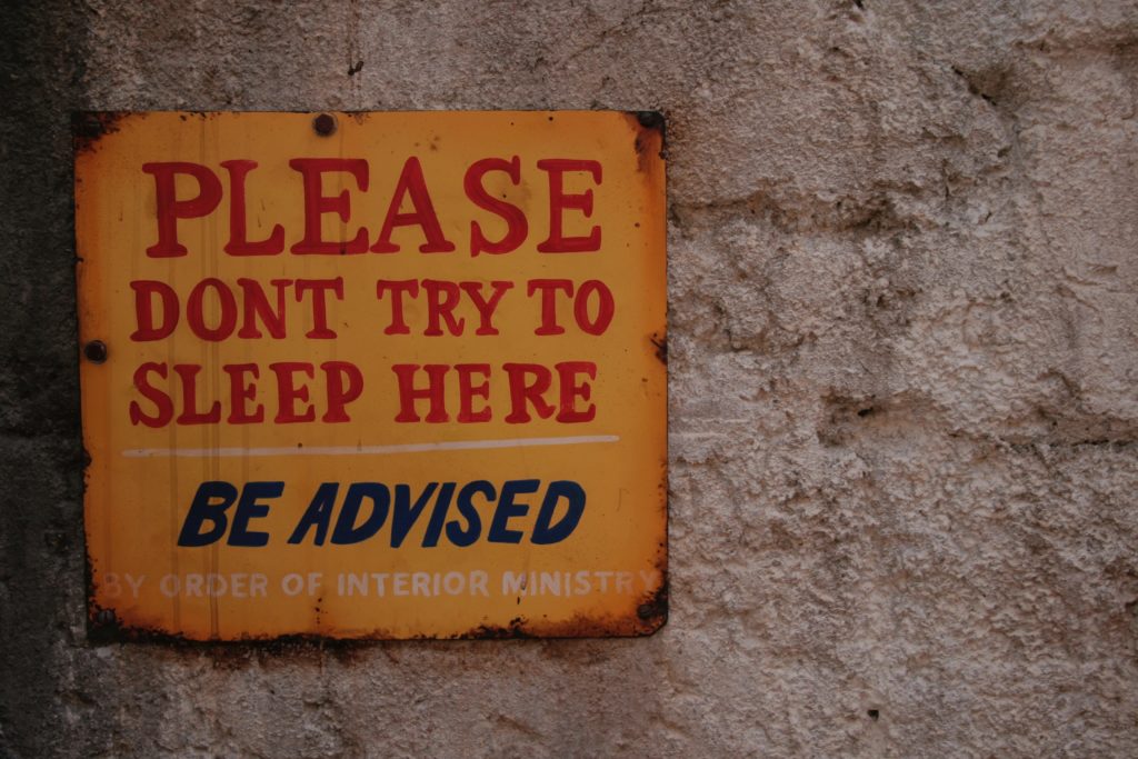Starting a PhD: yellow street sign saying please don't sleep here