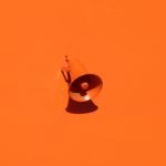 Orange microphone on orange background