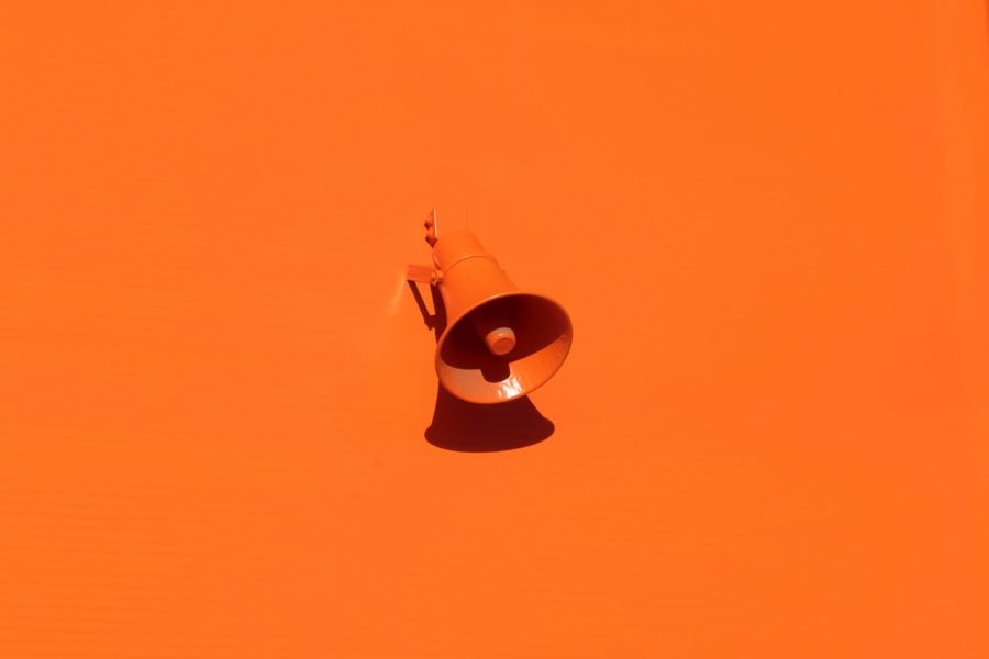 Orange microphone on orange background