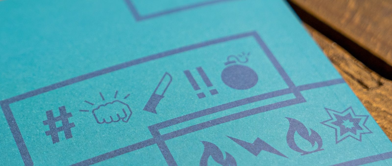 Blue book page showing speech bubbles with emojis